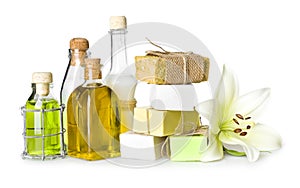 Spa bottles, soap pieces and lily isolated on white