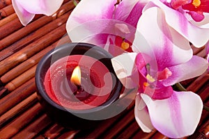 Spa candle and orchid flower for aromatherapy