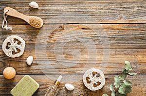 Spa composition with body care items on wooden background, top view.