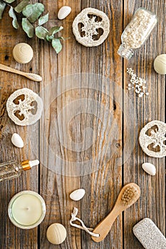 Spa composition with body care items on wooden background, top view.