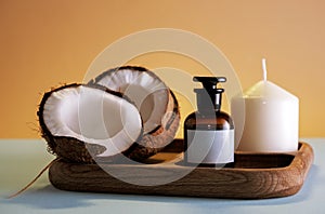 Spa composition with coconut, cosmetic product mock up bottle and white candle on a wooden tray