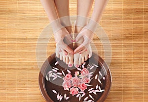 A spa composition of feet and hands in a bowl