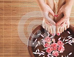 A spa composition of feet and hands in a bowl