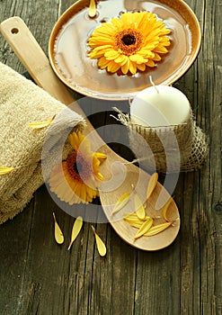 Spa composition of gerber flowers, candle and towe