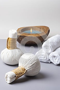 Spa composition of a herbal ball massage, towel with a candle