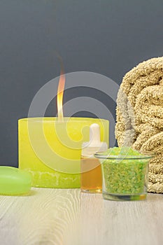 Spa composition with towel, sea salt, aromatic oil, soap and candle