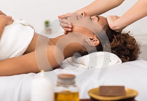 Spa concept. Afro woman getting professional face treatment