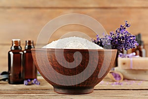 Spa concept. Bowl with sea salt and lavender flowers on wooden background