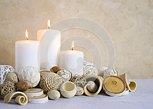 Spa concept of burning white candles decorated with natural dried potpourri