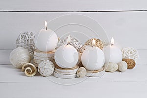 Spa concept of burning white candles decorated with natural dried potpourri