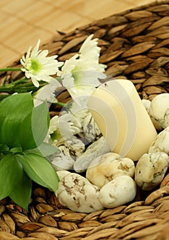 Spa concept. Candle, stones and flowers.