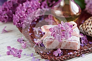 SPA concept: composition of spa treatment with natural sea salt, aromatic oil and lilac flowers