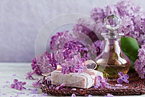 SPA concept: composition of spa treatment with natural sea salt, aromatic oil and lilac flowers