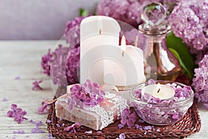SPA concept: composition of spa treatment with natural sea salt, aromatic oil and lilac flowers