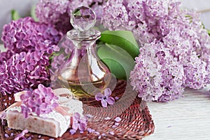 SPA concept: composition of spa treatment with natural sea salt, aromatic oil and lilac flowers