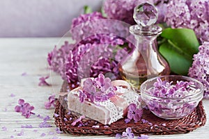 SPA concept: composition of spa treatment with natural sea salt, aromatic oil and lilac flowers