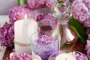 SPA concept: composition of spa treatment with natural sea salt, aromatic oil and lilac flowers