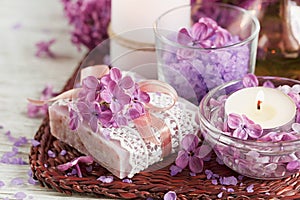 SPA concept: composition of spa treatment with natural sea salt, aromatic oil and lilac flowers