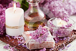 SPA concept: composition of spa treatment with natural sea salt, aromatic oil and lilac flowers