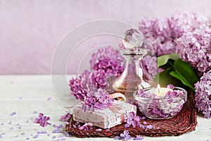 SPA concept: composition of spa treatment with natural sea salt, aromatic oil and lilac flowers