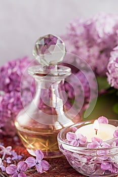 SPA concept: composition of spa treatment with natural sea salt, aromatic oil and lilac flowers