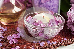 SPA concept: composition of spa treatment with natural sea salt, aromatic oil and lilac flowers