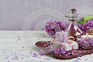 SPA concept: composition of spa treatment with natural sea salt, aromatic oil and lilac flowers