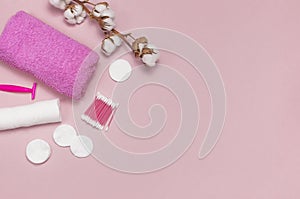 Spa concept. Flat lay background with cotton branch, cotton pads, eared sticks, pink towel. Cotton Cosmetic Makeup Removers