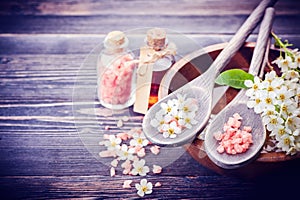 Spa concept. Flowers in bowl with water. Sea salt, essential oil massage