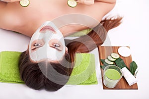 Spa concept. Hand applying nourishing mask on female face in spa