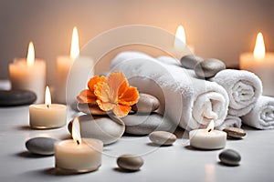 Spa concept, massage stones with towels, candles and orangeflowers.