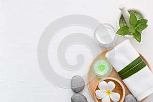 Spa concept with salt, mint, lotion, towel, candle, stone and fl