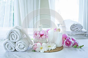 Spa concept. Spa treatment set and aromatic massage oil on bed massage. Thai setting for aroma therapy and massage with flower on