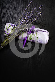 spa concept, towel with lavendet towel on wooden background
