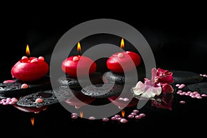 Spa concept of white and red orchid (cambria), three red candles