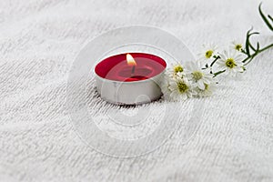 Spa concept with white towel decorated by cutter flower and red