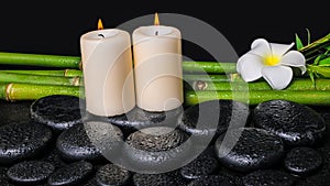 Spa concept of zen basalt stones, white flower plumeria, candles