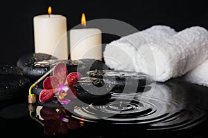 Spa concept of zen stones with drops, purple orchid