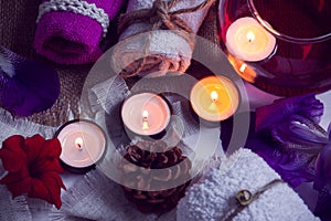 SPA consist from towels, candles, flowers, cone and aromatherapy water in a glass bowl