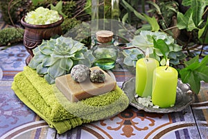 Spa cosmetics: sea salt, bottle of essential oil, bar of handmade soap and scented candles
