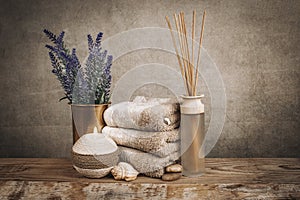 Spa essentials, aroma sticks, stones, towels, sea shell on a wooden rustic background