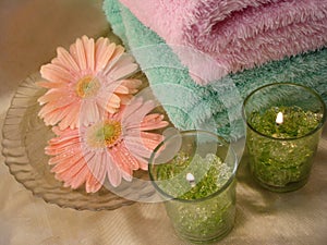 Spa essentials (green candles and towels with flowers)