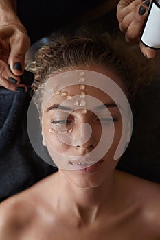 Spa Face Mask. Skin Care Beauty Treatment For Female. Beautician Applying Facial Oil Drops.