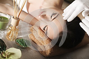 Spa. Face massage. Spa skin and body care. Close-up of young woman getting spa massage treatment at beauty spa salon. Facial beau