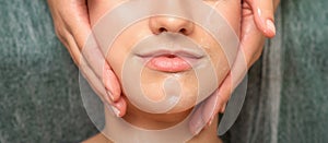 Spa facial skincare. Close-up of a young caucasian woman getting spa moisturizing face massage treatment at beauty spa