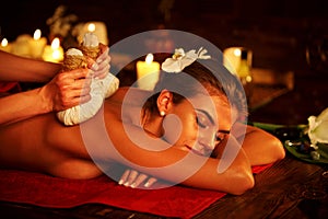 Spa gifts of woman massage in spa salon. Female have herbs hot ball therapy.