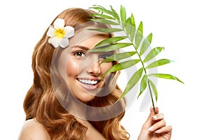 Spa girl. beauty Young Woman with Clean Fresh Skin with tropical leaves. Facial treatment. Model with Expressive facial expression