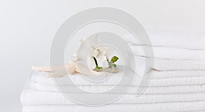 Spa and health care concepts setup with stack of white towels star fish,Gardenia flowers on white background