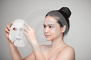 Spa, healthcare. Asian girl with a cosmetic mask.