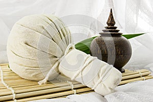 Spa herbal ball, herbs casket and leaf on bamboo mat